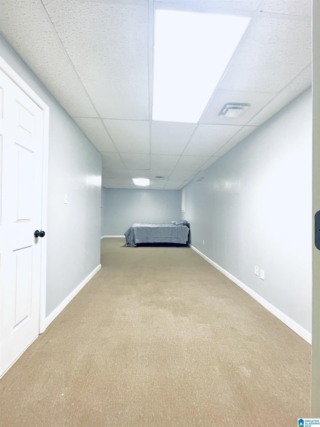 unfurnished bedroom with carpet and a drop ceiling