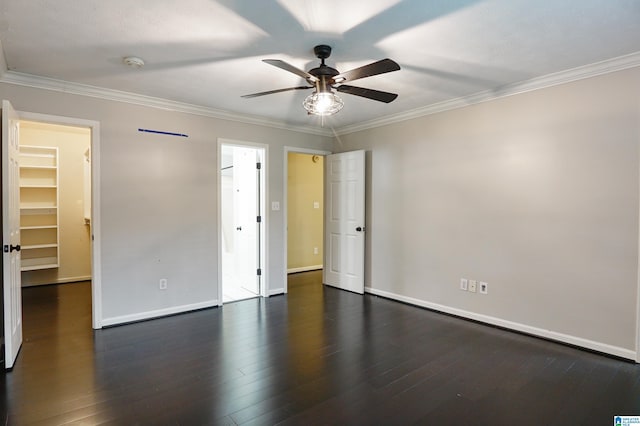 empty room with ceiling fan, dark hardwood / wood-style flooring, and ornamental molding