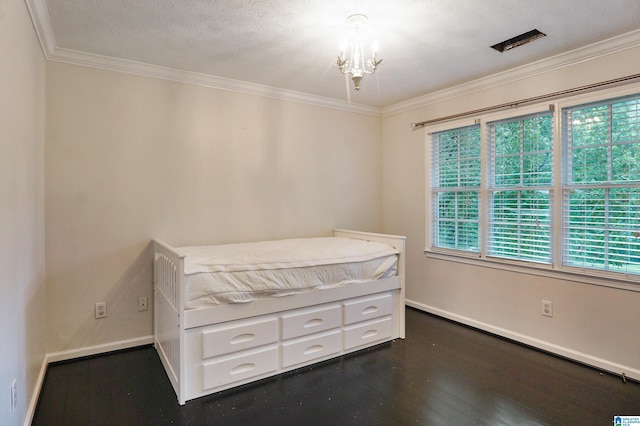 unfurnished bedroom with dark hardwood / wood-style floors, ornamental molding, a textured ceiling, and an inviting chandelier