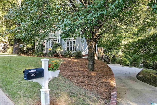 obstructed view of property featuring a front lawn