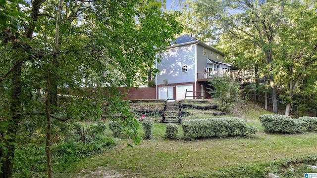 view of yard featuring a garage and a wooden deck