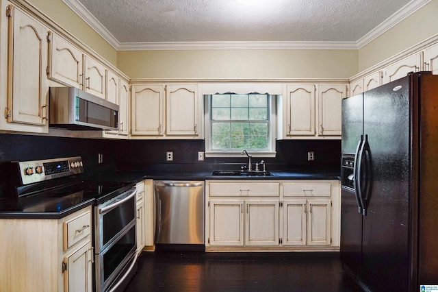 kitchen featuring a textured ceiling, ornamental molding, sink, and appliances with stainless steel finishes