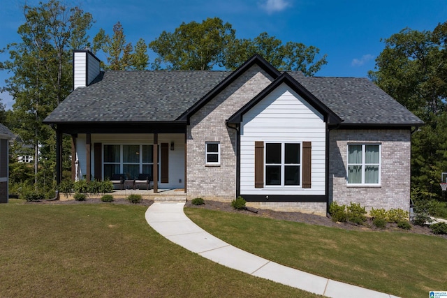 view of front of house with a front yard and covered porch