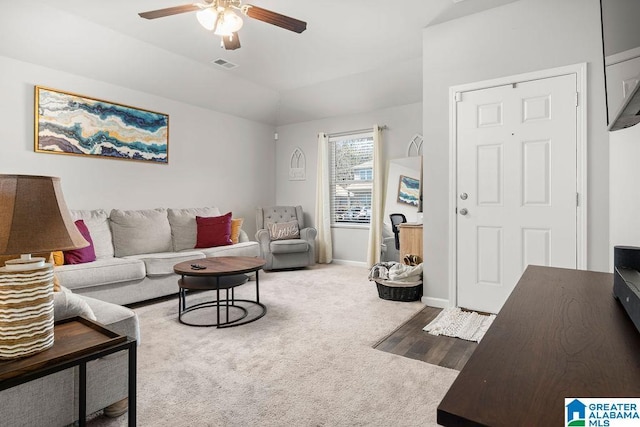 carpeted living room featuring ceiling fan and vaulted ceiling