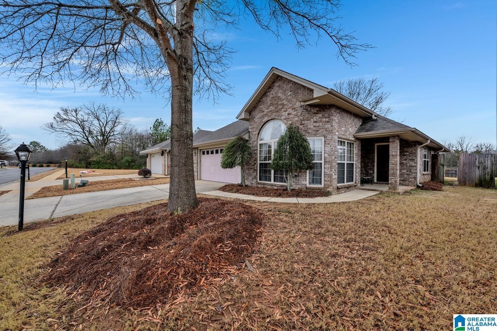 view of front of house featuring a garage and a front lawn