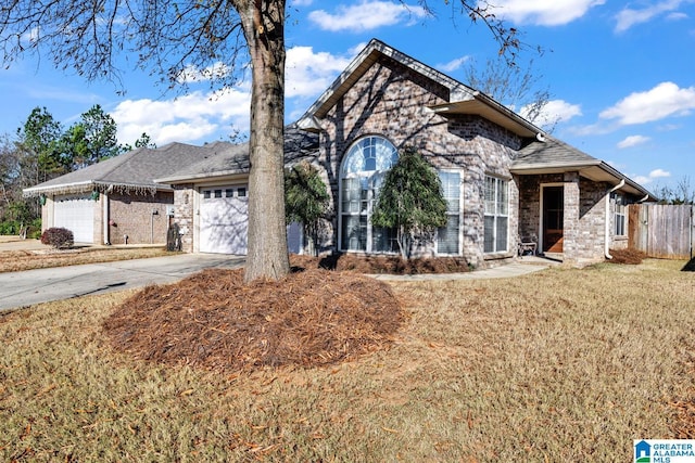 view of front of property featuring a garage and a front lawn