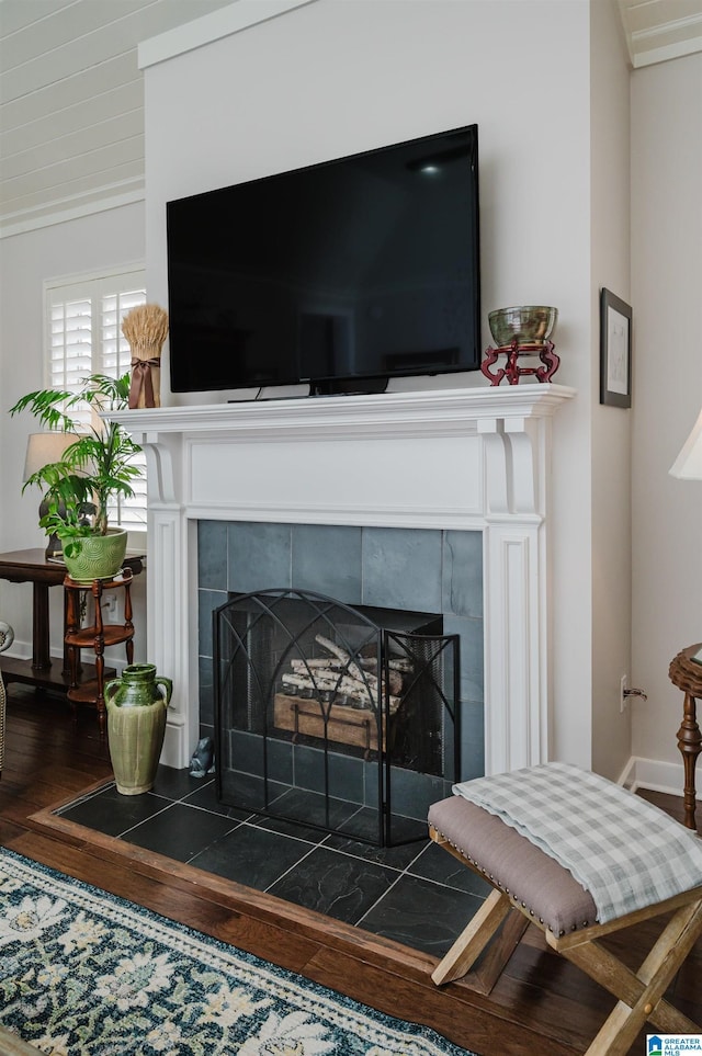 interior details with a tile fireplace and hardwood / wood-style floors