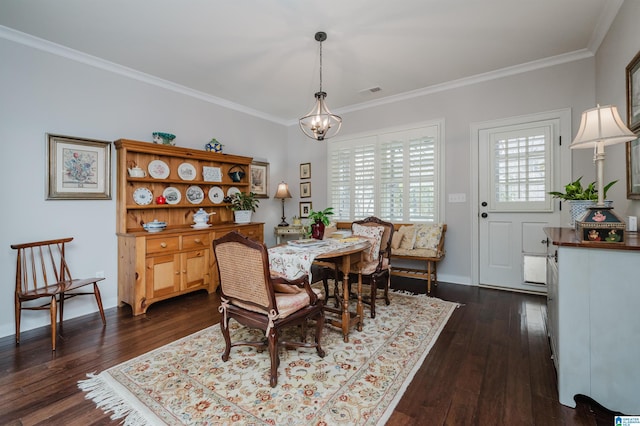 dining room with ornamental molding, dark wood-type flooring, and an inviting chandelier