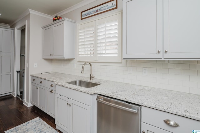 kitchen featuring backsplash, dishwasher, light stone counters, and sink