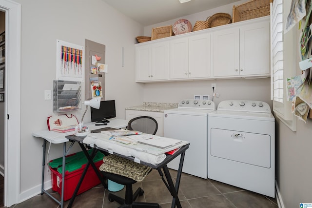 laundry room with cabinets, dark tile patterned floors, and washer and dryer