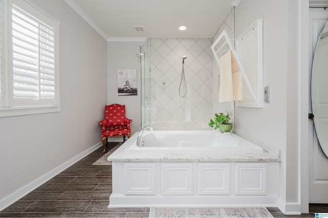 bathroom featuring ornamental molding and shower with separate bathtub