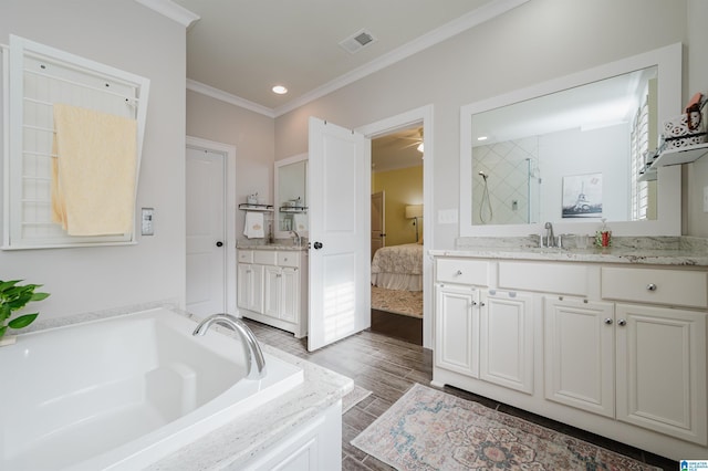 bathroom featuring vanity, a tub, and ornamental molding