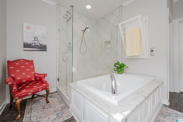 bathroom with ornamental molding and plus walk in shower