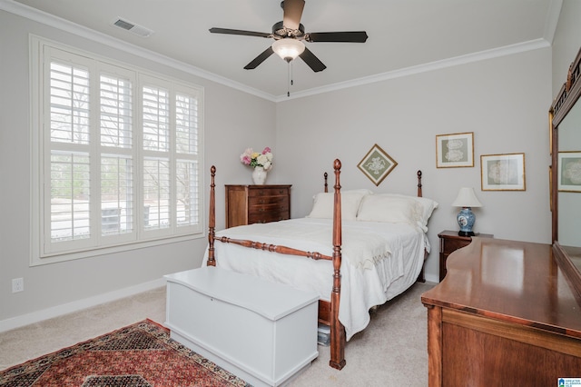 carpeted bedroom featuring ceiling fan and ornamental molding