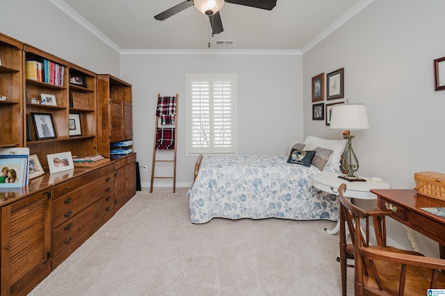 carpeted bedroom with ceiling fan and ornamental molding