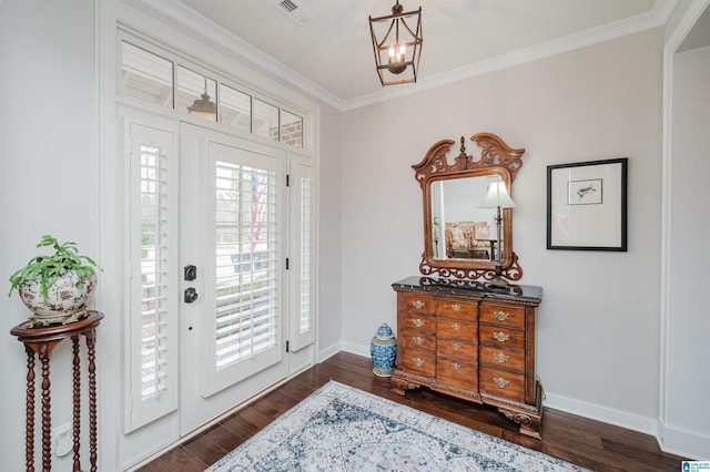 entrance foyer featuring a chandelier, dark hardwood / wood-style floors, and ornamental molding