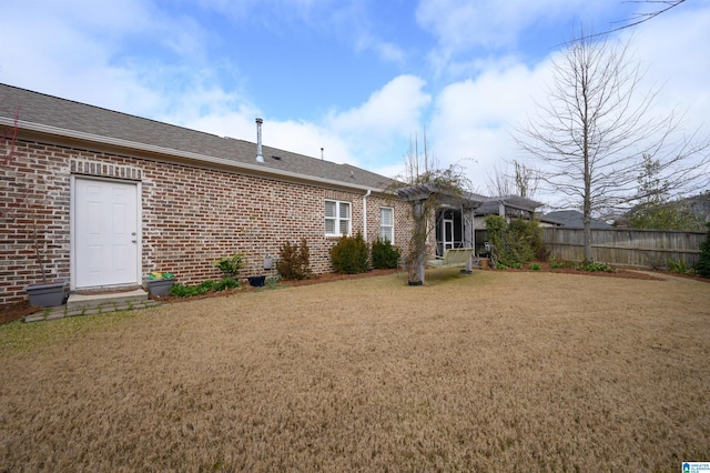 back of property featuring a yard