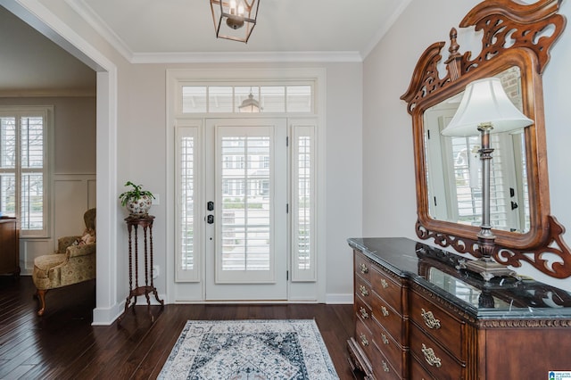 entryway with dark hardwood / wood-style floors and ornamental molding