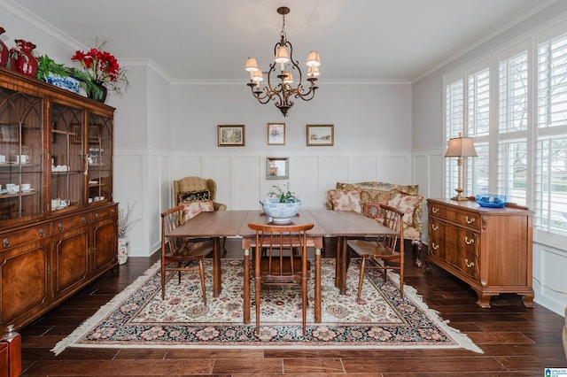 dining room with a notable chandelier, dark hardwood / wood-style floors, and ornamental molding