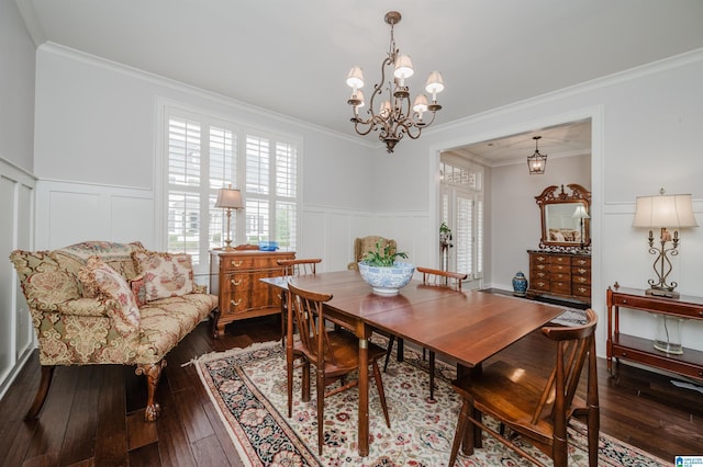 dining space with crown molding and a chandelier