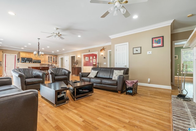 living room with ceiling fan with notable chandelier, light wood-type flooring, and ornamental molding