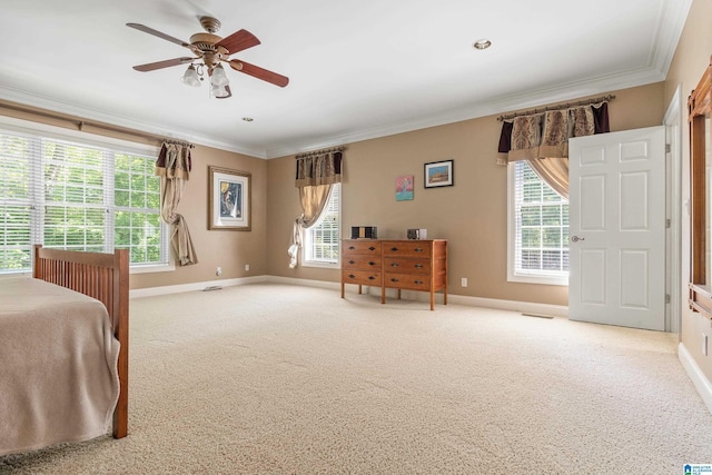 carpeted bedroom with ceiling fan and crown molding