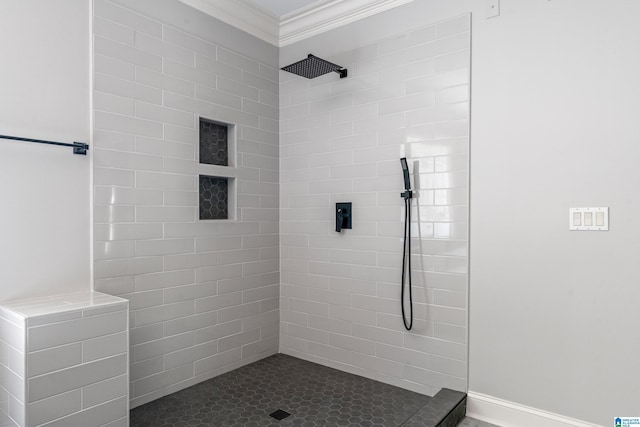 bathroom featuring a tile shower and ornamental molding