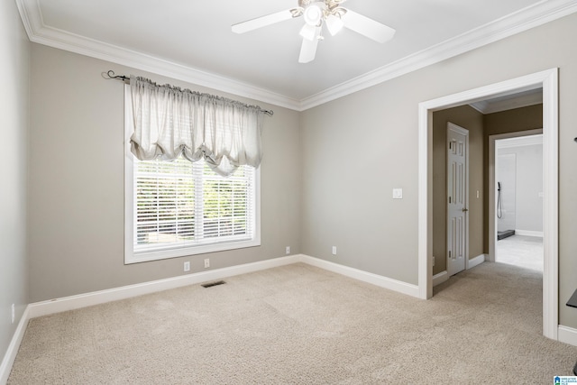 unfurnished room with light carpet, ceiling fan, and crown molding