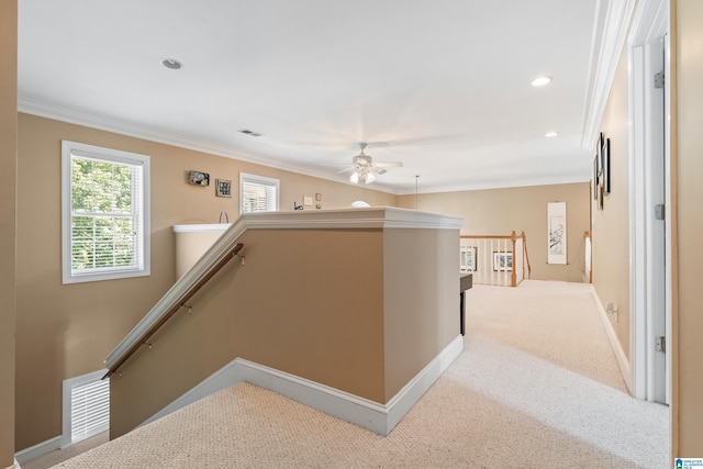 hall featuring ornamental molding and light carpet