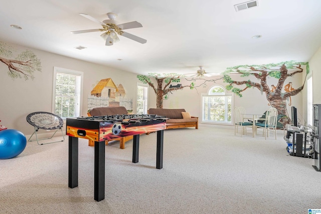 playroom with ceiling fan and light carpet