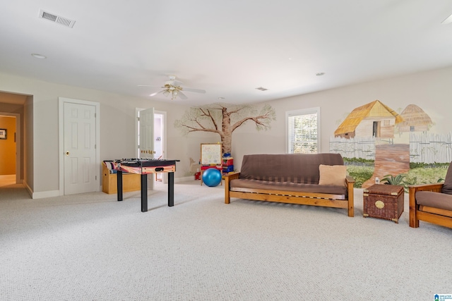 recreation room with ceiling fan and carpet