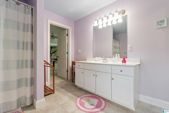 bathroom with tile patterned floors, ceiling fan, vanity, and walk in shower