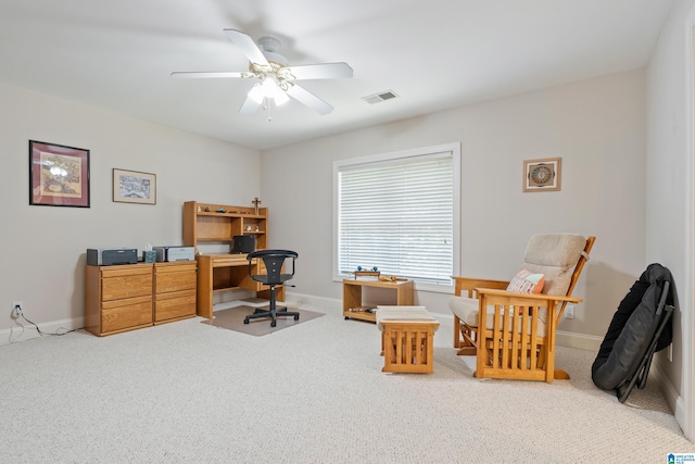 carpeted office space with ceiling fan