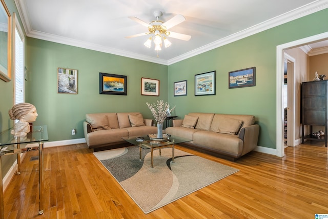 living room featuring a wealth of natural light, crown molding, hardwood / wood-style floors, and ceiling fan