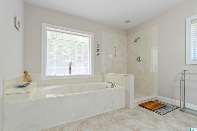 bathroom featuring plus walk in shower and tile patterned flooring