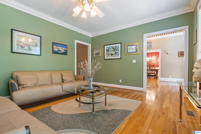 living room with hardwood / wood-style floors, ceiling fan, and ornamental molding