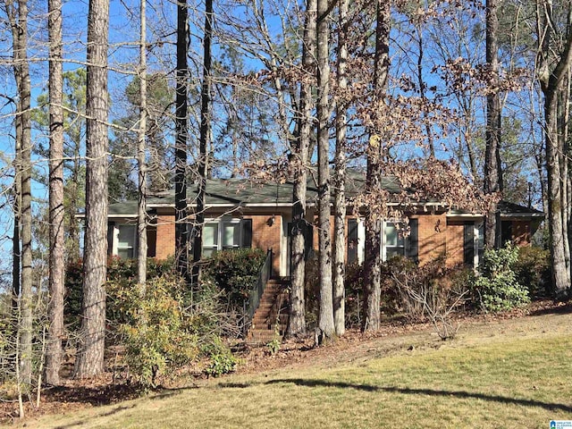 obstructed view of property featuring a front yard