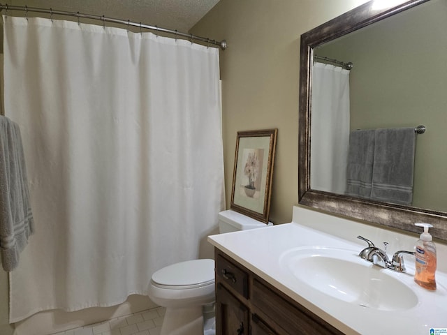 bathroom featuring vanity, a textured ceiling, tile patterned floors, and toilet