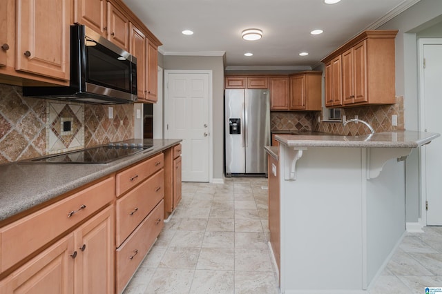 kitchen featuring decorative backsplash, a breakfast bar, stainless steel appliances, and ornamental molding