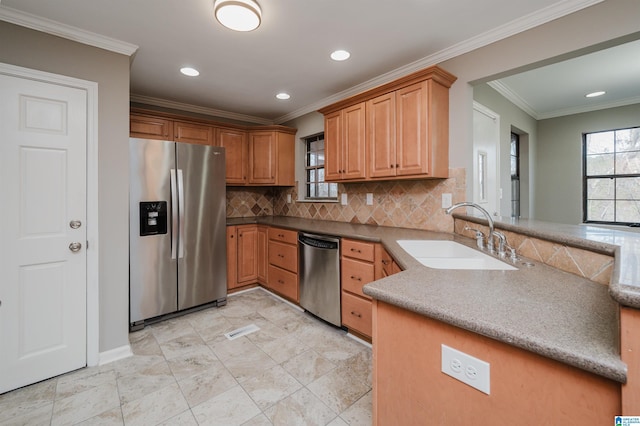 kitchen with sink, decorative backsplash, ornamental molding, kitchen peninsula, and stainless steel appliances