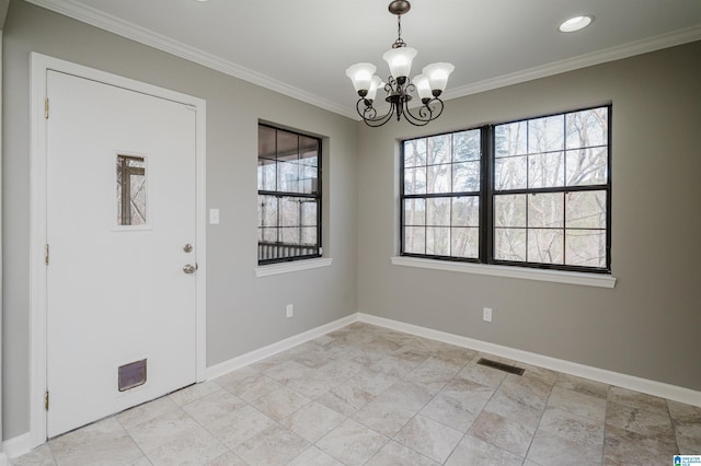 foyer entrance featuring crown molding and a notable chandelier