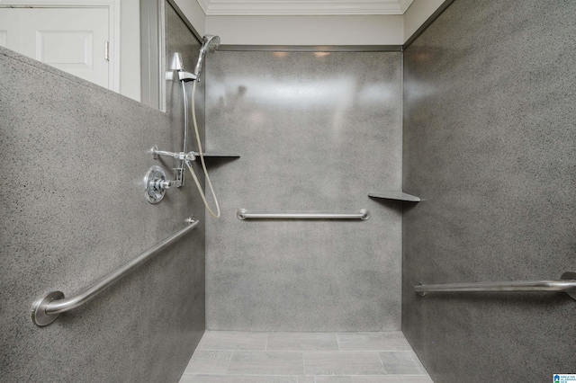 bathroom featuring ornamental molding and walk in shower