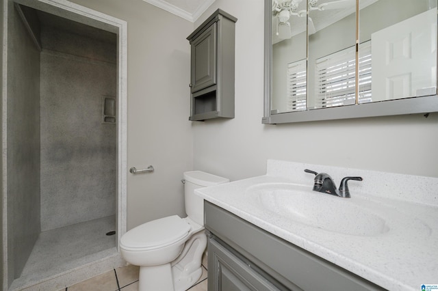 bathroom with vanity, a shower, tile patterned floors, crown molding, and toilet