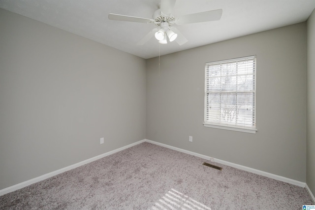 carpeted empty room featuring ceiling fan