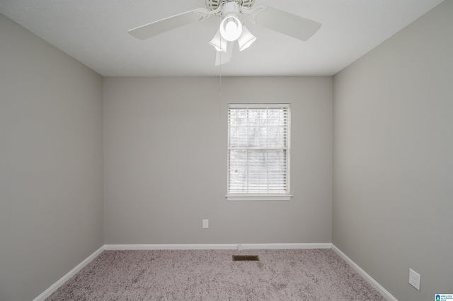 empty room featuring light colored carpet and ceiling fan