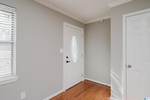 foyer entrance featuring hardwood / wood-style flooring and ornamental molding