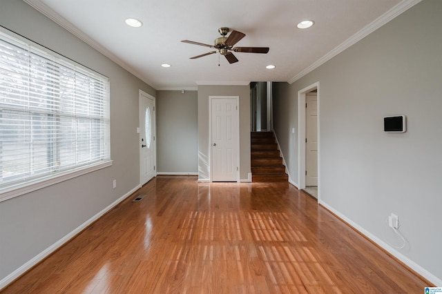 spare room featuring ceiling fan, hardwood / wood-style floors, and ornamental molding