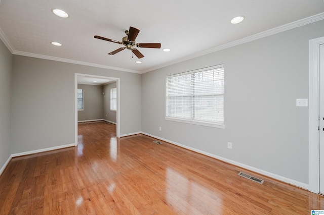 empty room featuring hardwood / wood-style flooring and ornamental molding