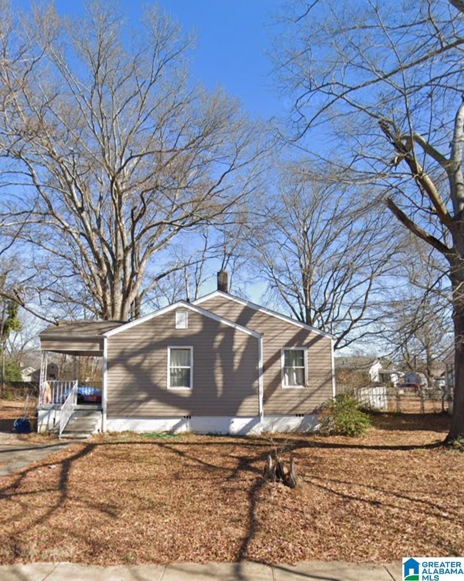 view of side of property featuring a carport