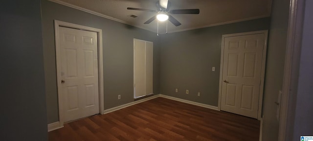 unfurnished bedroom with ornamental molding, ceiling fan, and dark wood-type flooring